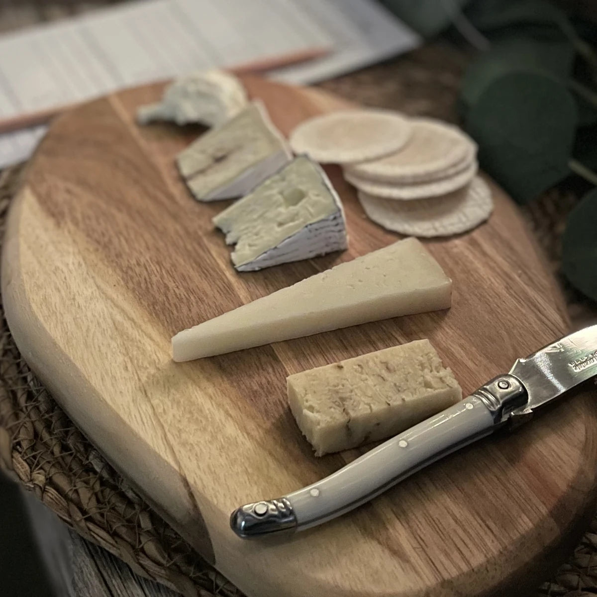 Cheese board with brie, blue and hard cheese, crackers and a Laguiole knife, set for a wine and cheese tasting